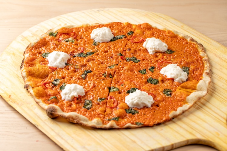 A vodka pizza with chunks of mozzarella.